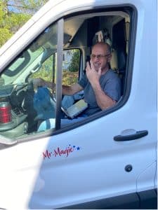The Magic Man driving a van.