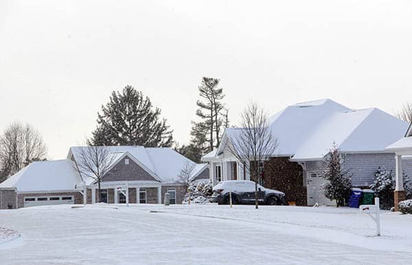 A snow covered street in a residential neighborhood transformed by The Magic Man.