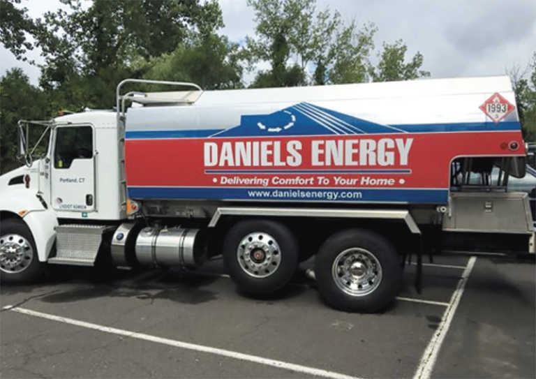 A Daniels Energy truck, owned by an environmentally friendly oil company, parked in a parking lot.