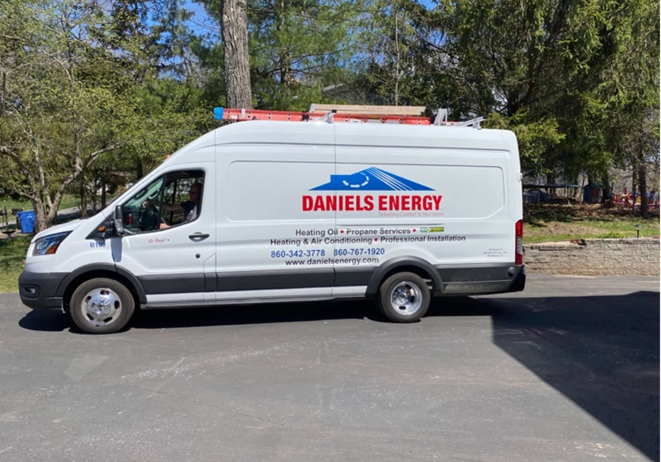 A white van with the words daniel's energy on it, driven by The Magic Man.